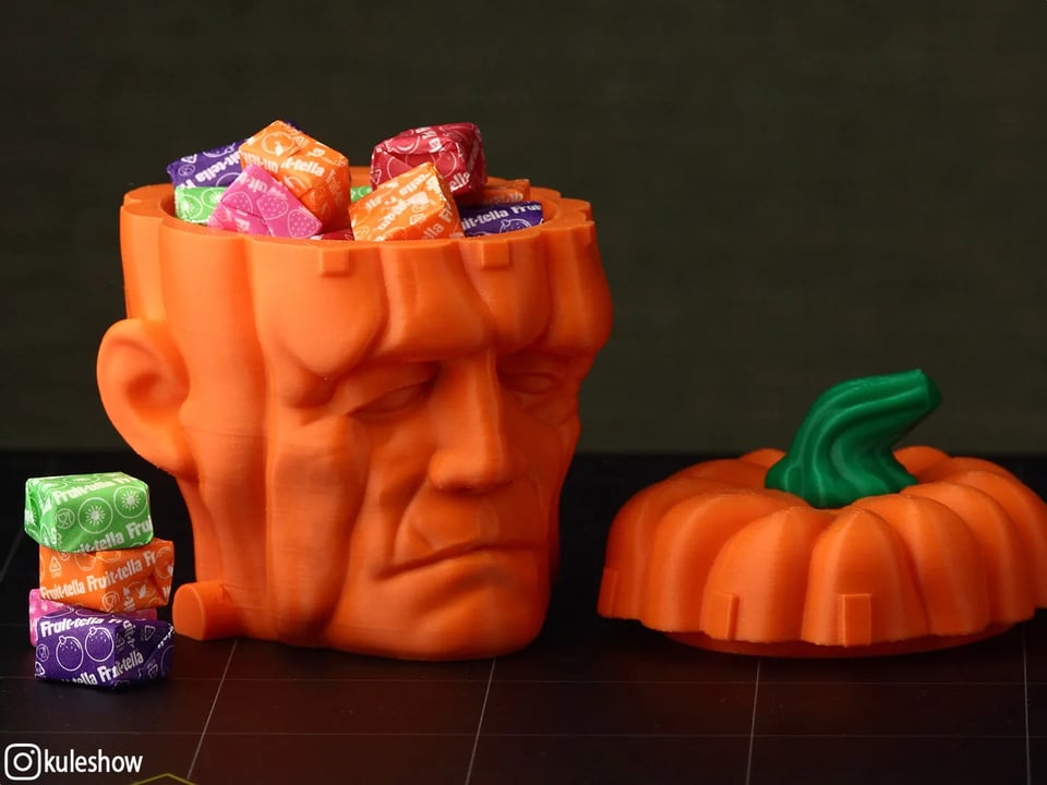 A candy bowl made out of a Frankenstein head that is also a pumpkin