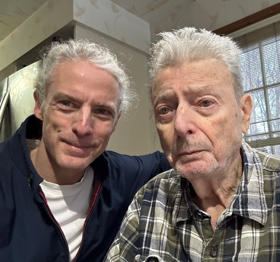 Selfie of two white men inside a house, father & son: son is 54 and dad is 88
