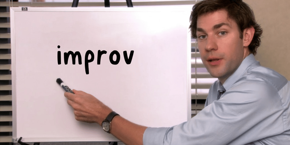 Jim from The Office points to a whiteboard with IMPROV written on it.