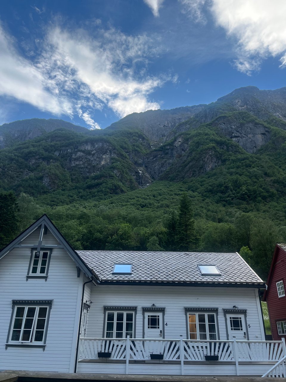 White house in front of mountains and clouds and sky