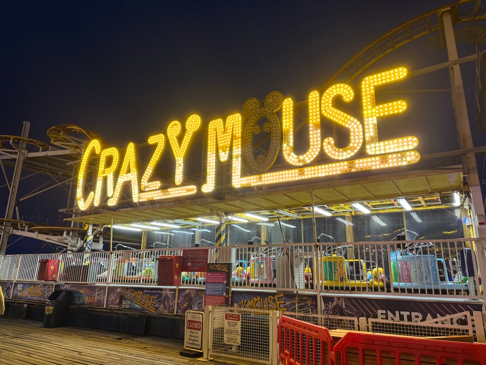 A carnival ride called "Crazy Mouse" but the U is dark, making it say "Crazy Muse"