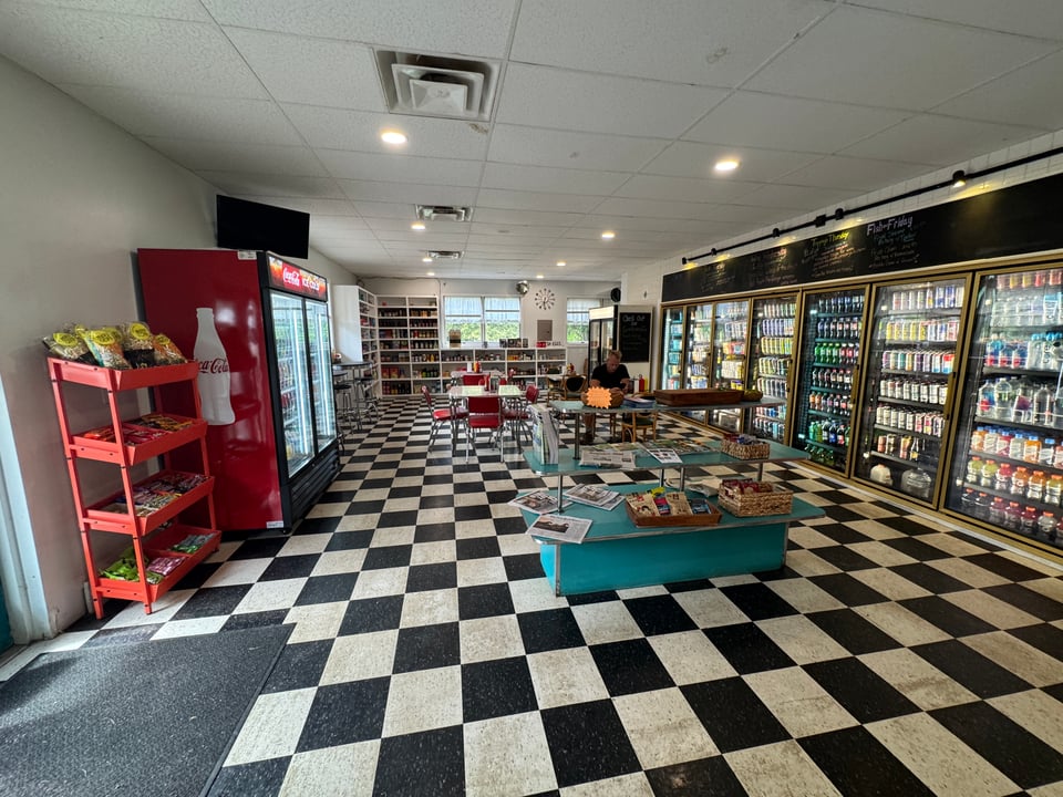 Kiki's Convenience, black and white tile floors and a lot of beverages.