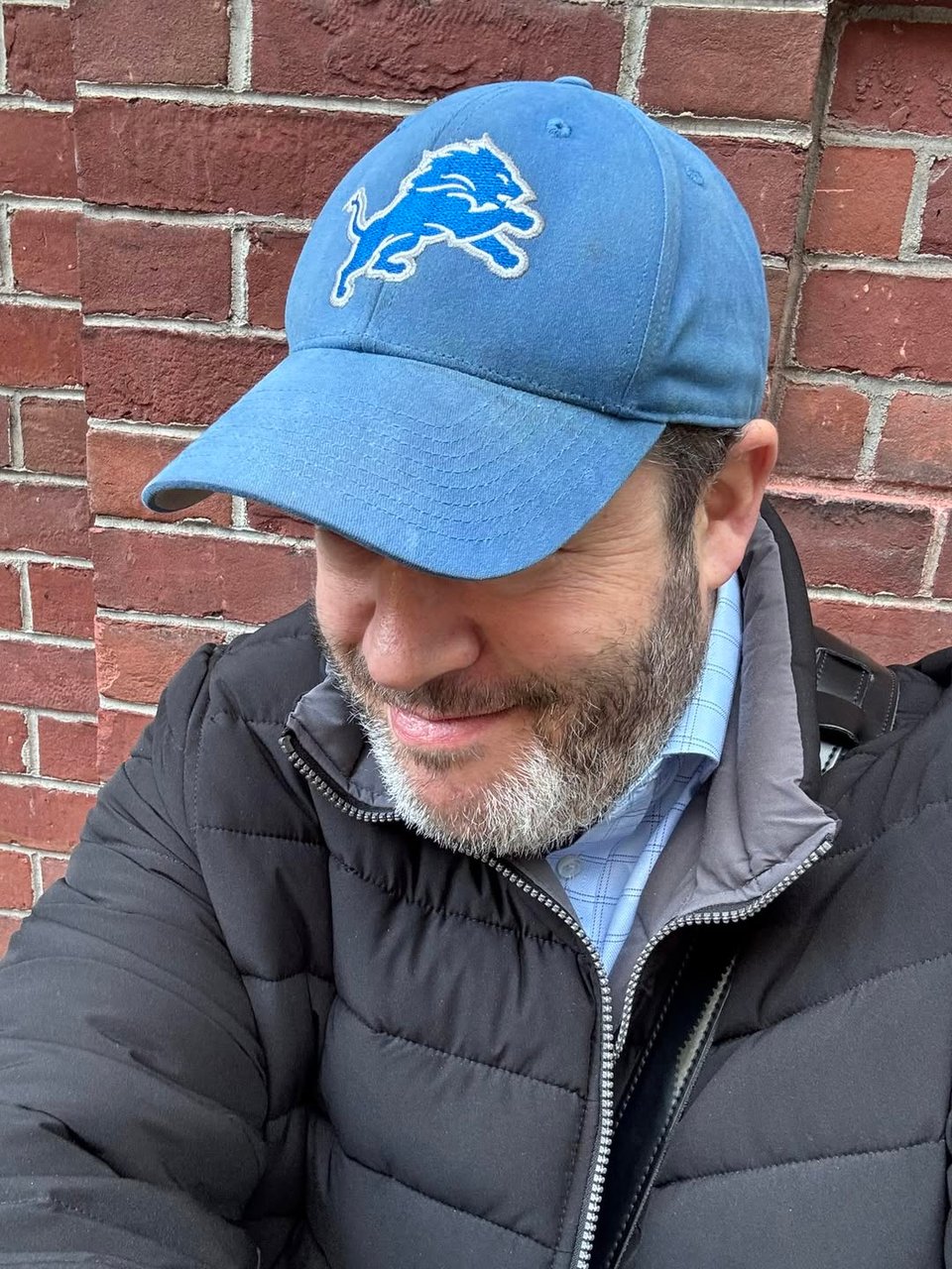 Neil in NYC, wearing a Detroit Lions baseball cap