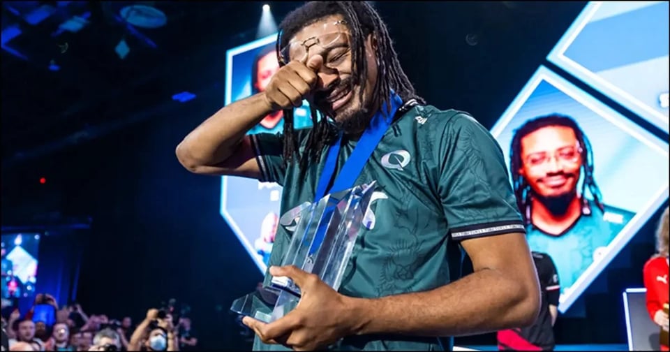 Street Fighter 6 esports player Punk holds his first-place trophy after a last-round victory.