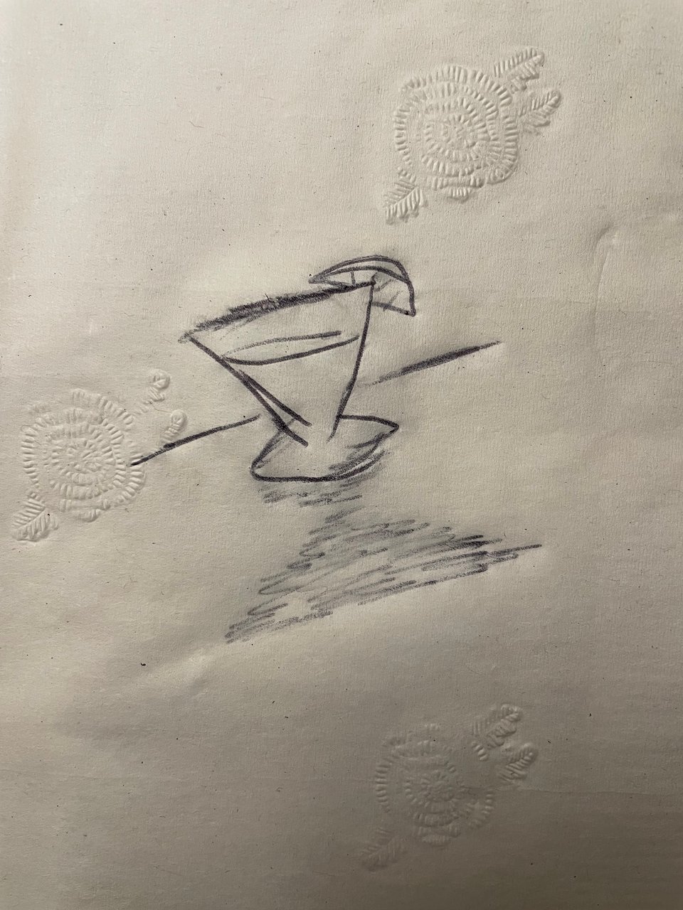 A rough sketch of a martini in a low glass on a cocktail napkin