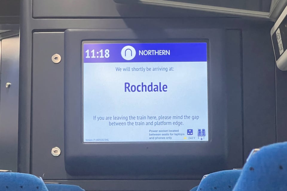 An in-train display announcing that the next station is “Rochdale”