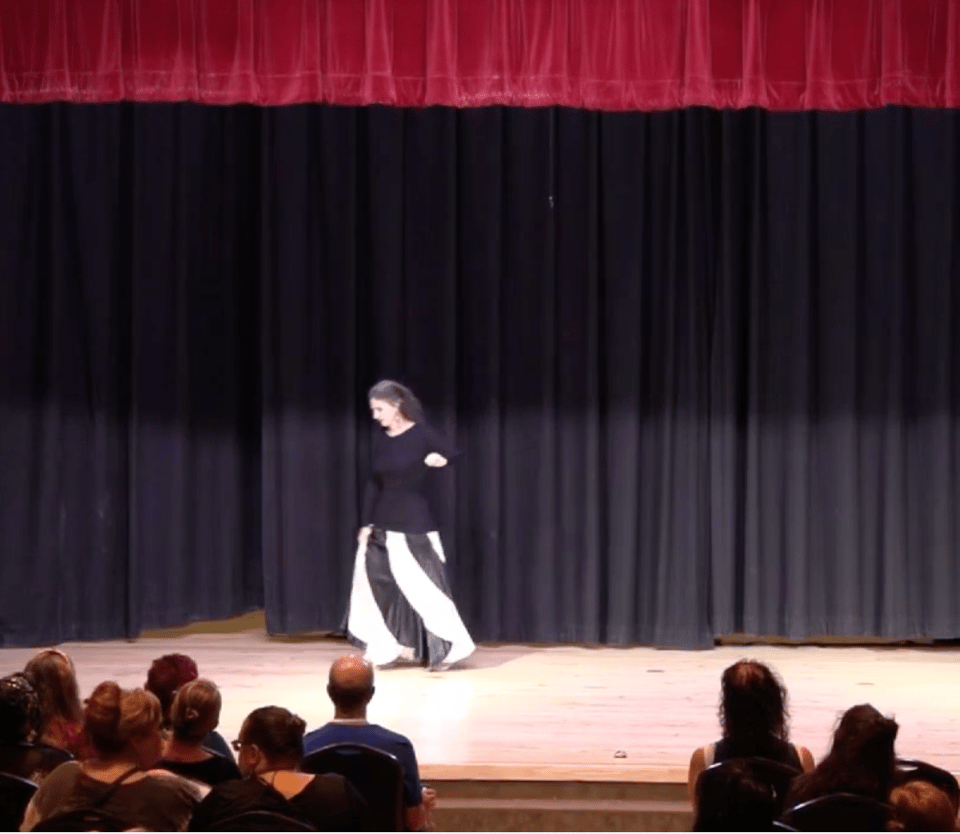 Photo description: A dancer in black and white on a stage