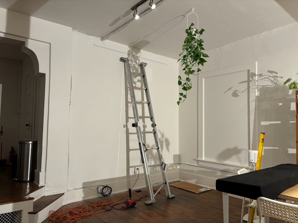 A well-lit ladder on a wall.