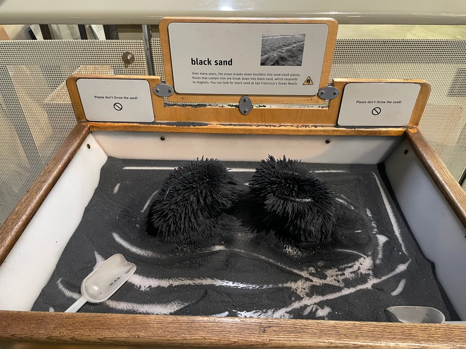 Black sand is attached to metal underneath.