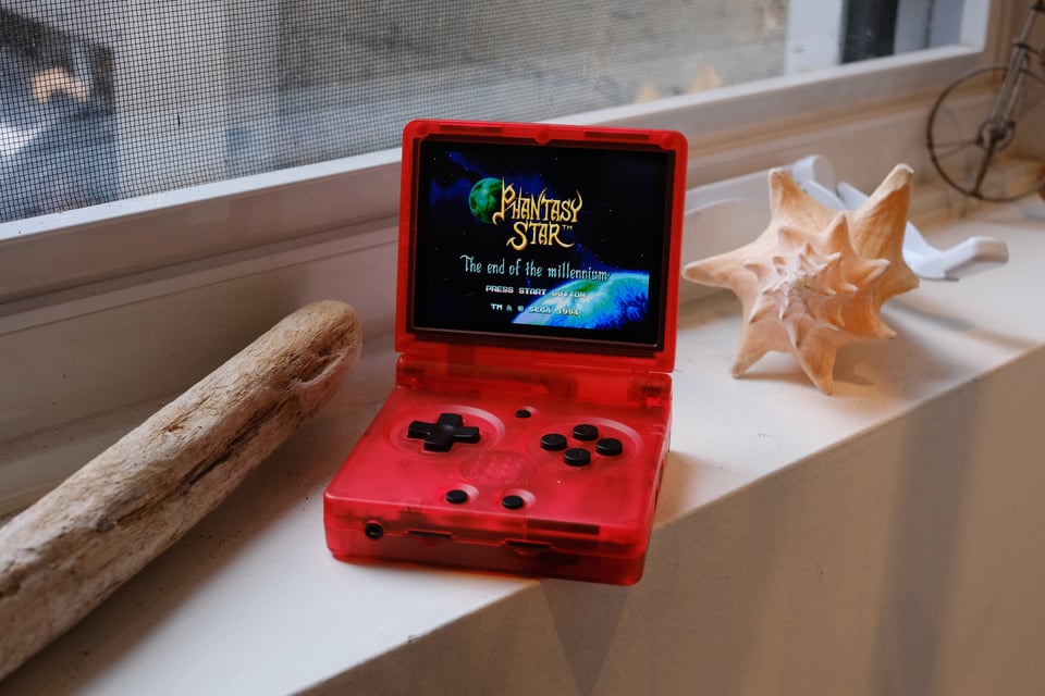 A red Anbernic video game device