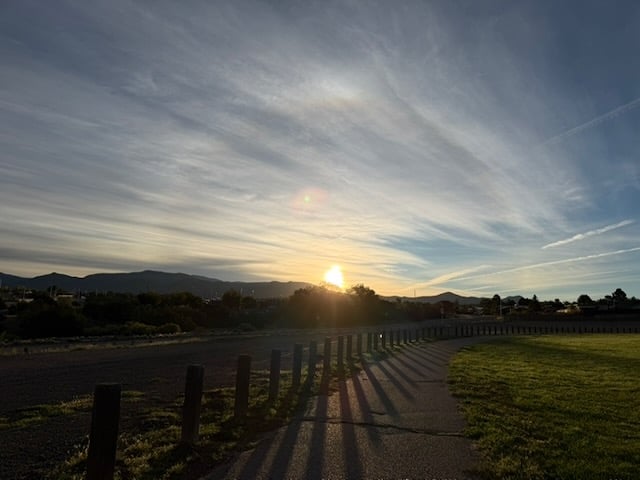 Eastern view of Sangre de Cristo mountains at sunrise. Sky is streaked with clouds and patches  of blue break through.