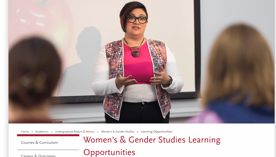 an image of a chicana professor standing in front of a screen in a classroom