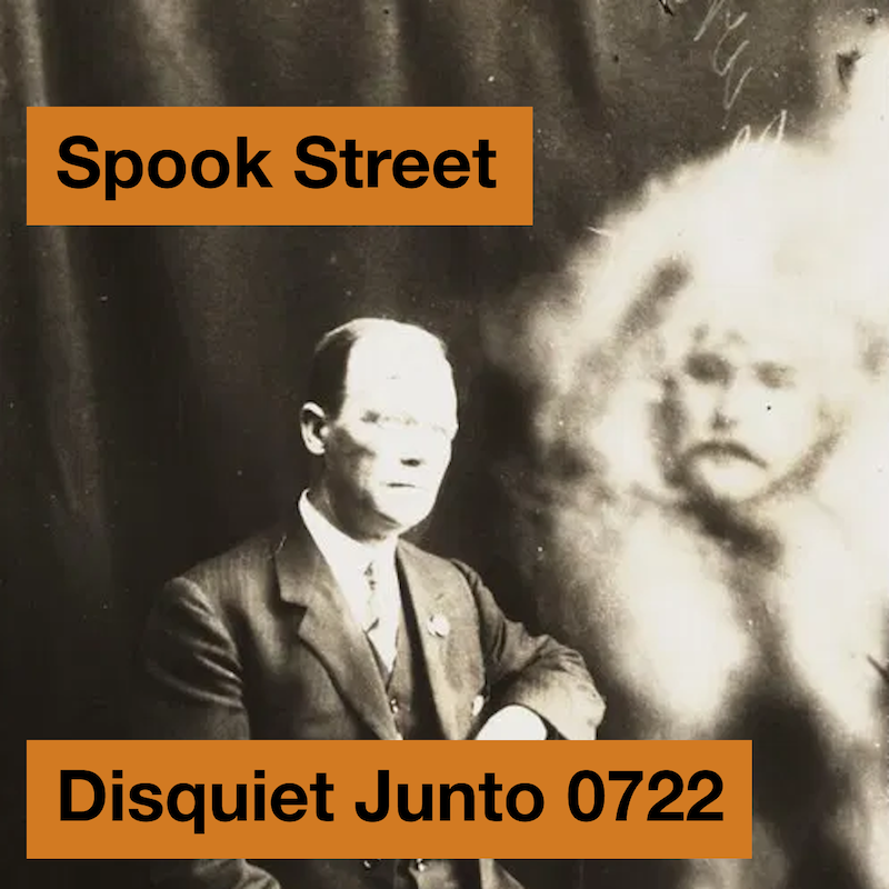 The image shows a man in a suit with a ghostly apparition in the background, plus the name and number of the project