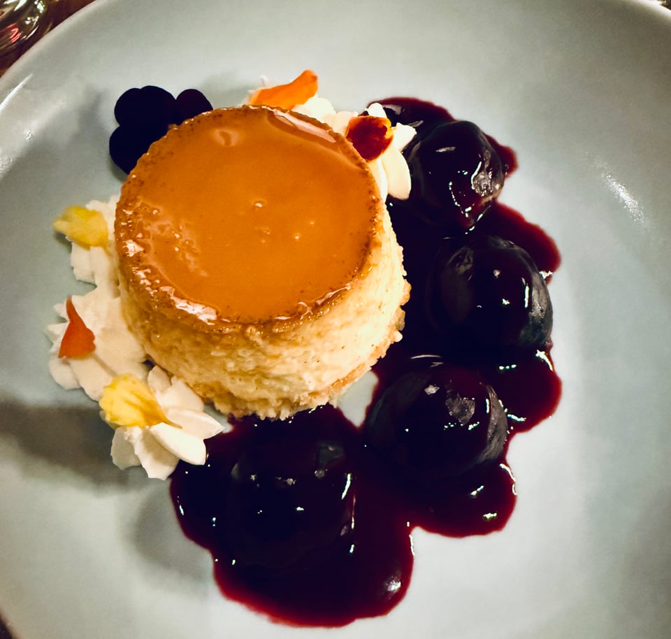panna cotta surrounded by piped whipped cream flowers and cassis-soaked figs at El Fish Marisqueria in New York City
