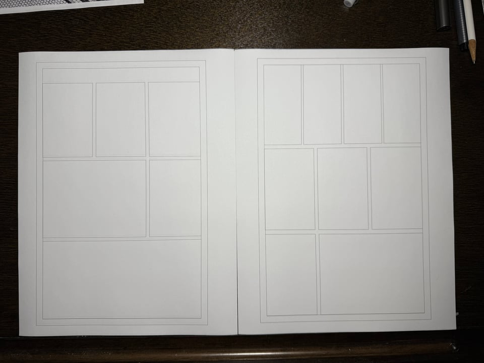photo of 2 pages of printer paper with rectangles printed on them in the layout of a couple pages of comics