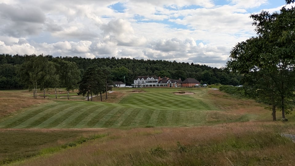 Sherwood Forest 18th fairway and green in June, clubhouse in the background, par 3 4th green on the left