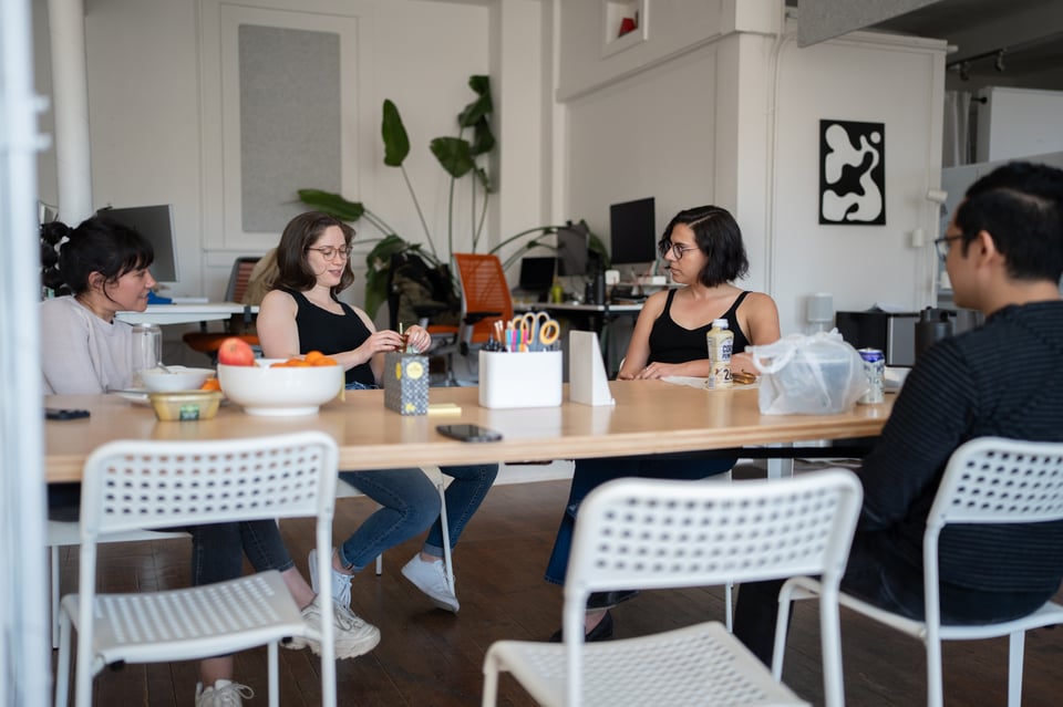 People sitting around a table talking.
