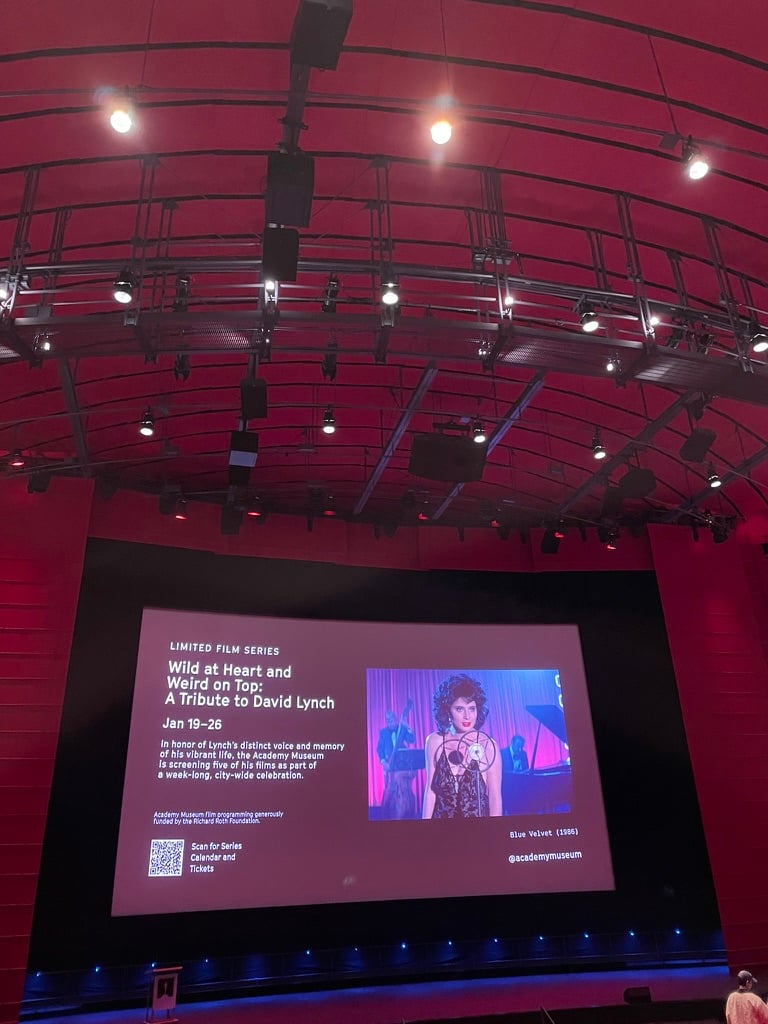 An ad for David Lynch films with a picture from Blue Velvet. The screen is in a giant red theater