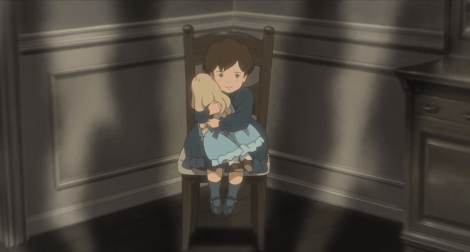 A young Anna sits in a chair in a dark room. She is upset and clutching a doll with the same hair color, hairstyle, and dress as Marnie.