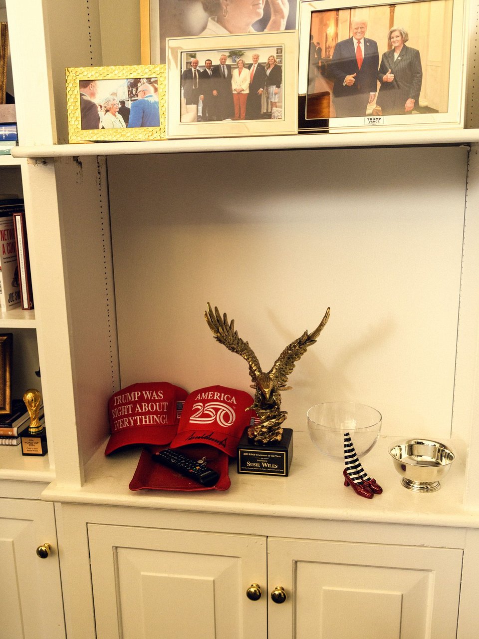 Wiles’s office bookshelf featuring a replica FIFA trophy and some unsubtle Wicked Witch imagery.