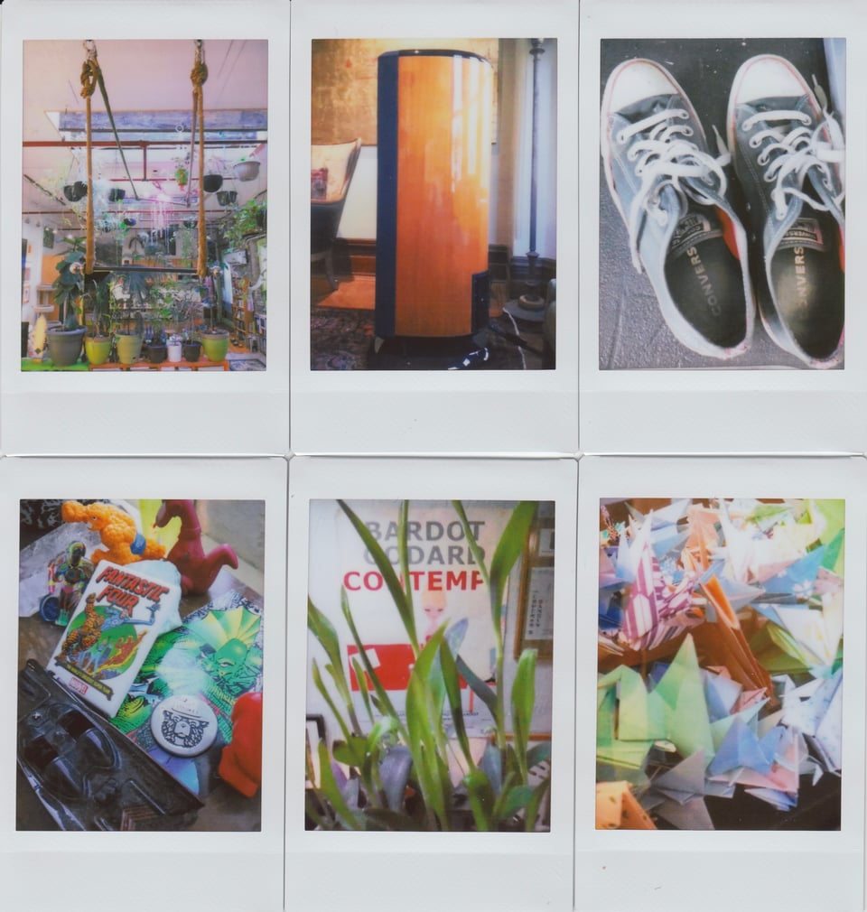 6 Instax photos: top row, left; a trapeze set up in an apartment with a lot of plants; center, a high-end stereo speaker with a lacquered wood finish; right, a pair of black low-cut Converse Chuck Taylors; bottom row, left; superhero/comic tchotchkes on a drawing table; center, a poster for Godard's CONTEMPT obscured by bamboo leaves; right, a collection of colored origami cranes