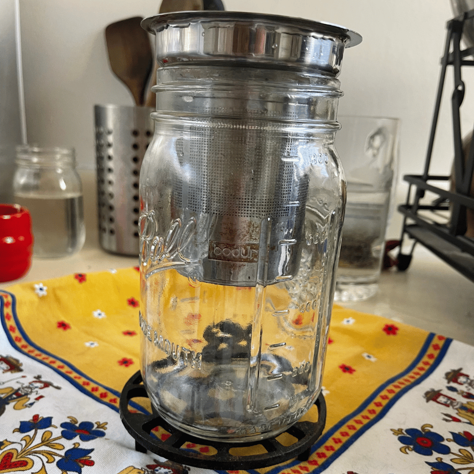 A strainer in a jar for making drip coffee