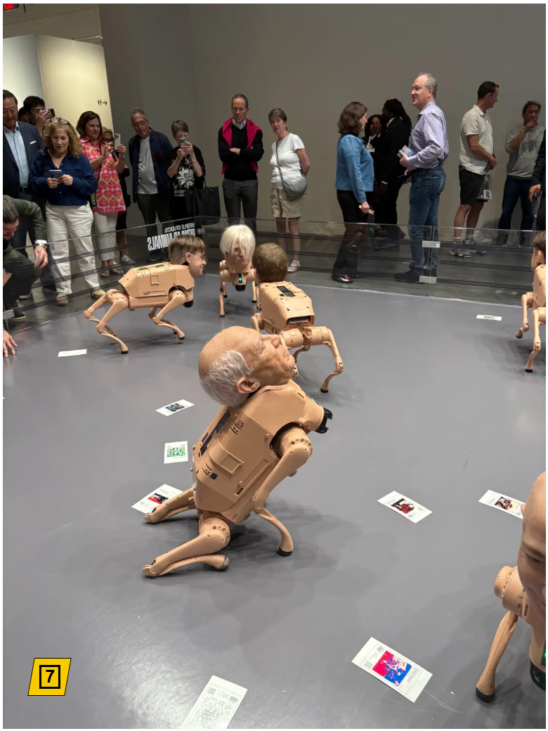 Photo of an "art exhibition" where robot dogs, with fake heads, wandering an enclosure, sometimes in a pose to suggest that the robot dog is "pooping". Scattered print-outs are discarded on the floor.