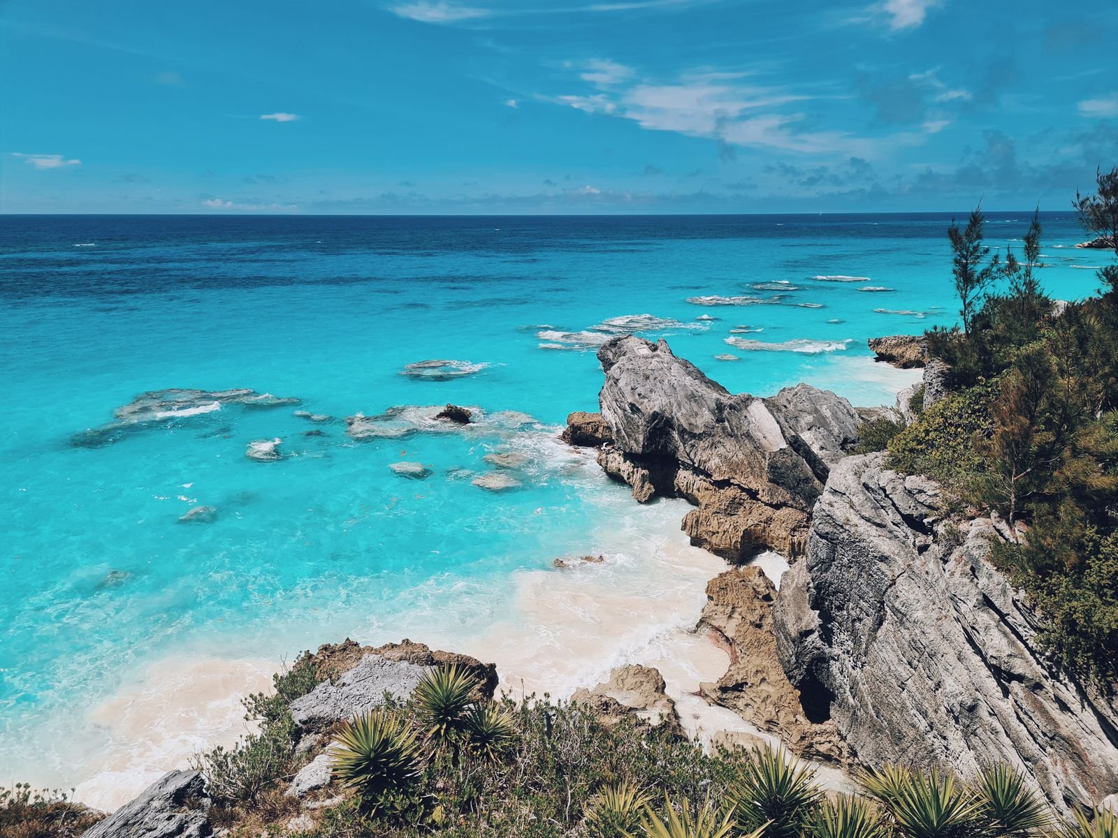 Bermuda's turquoise coastline with rocky cliffs and lush green vegetation