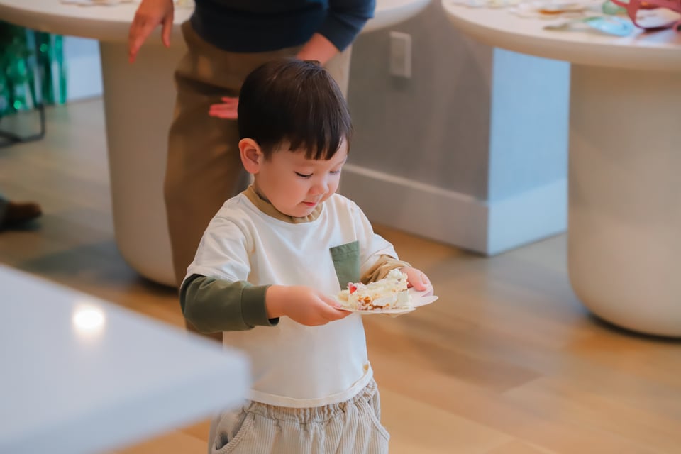 a cutie patootie carrying a slice of cake