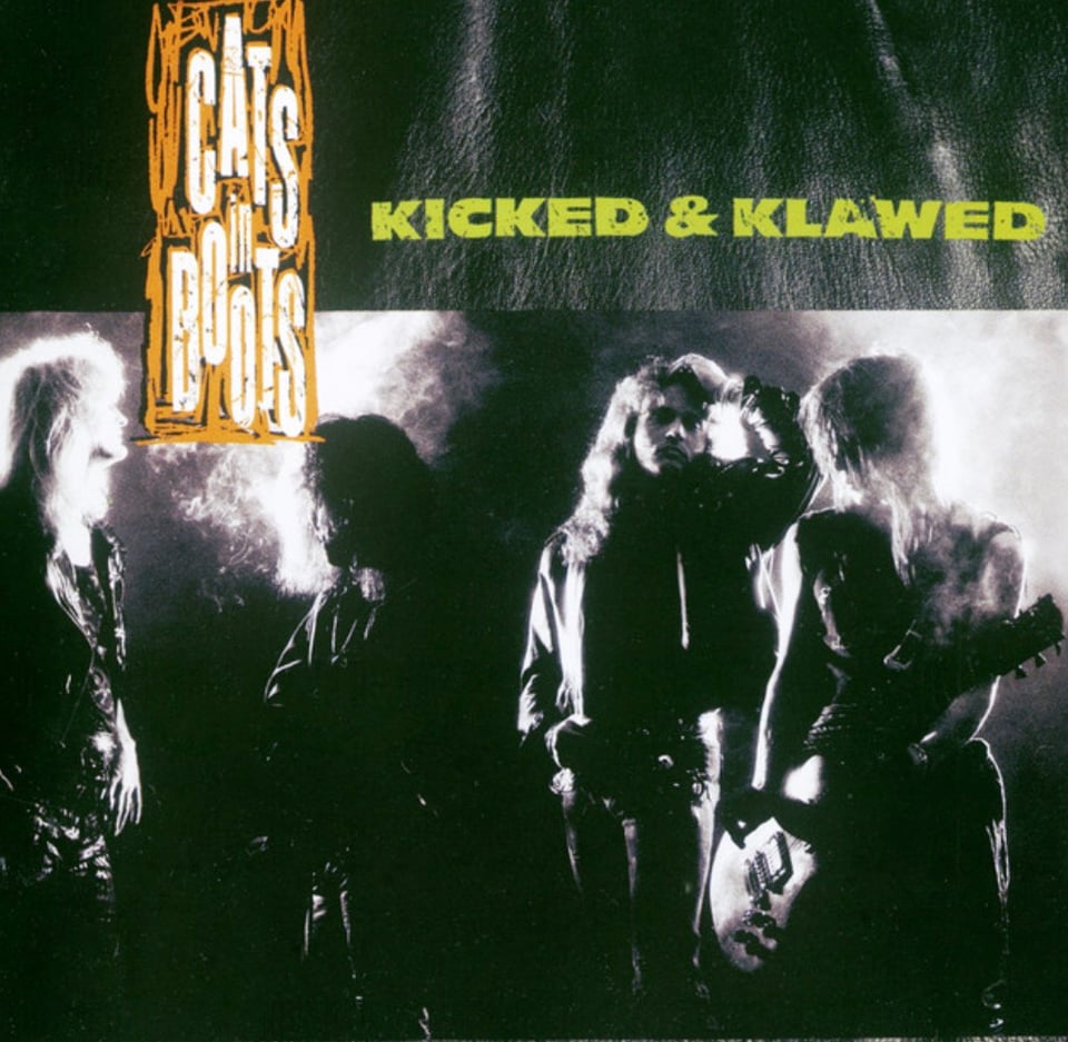 The album cover for Cats in Boots’ KICKED & KLAWED, which is a black and white photo of four male musicians, mostly with their faces obscured and bodies in shadow, but you can tell from the hair this is Sunset Strip territory.