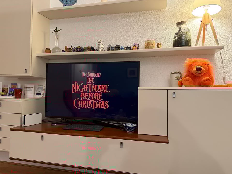 A large TV screen shows "Tim Burton's The Nightmare before Christmas".