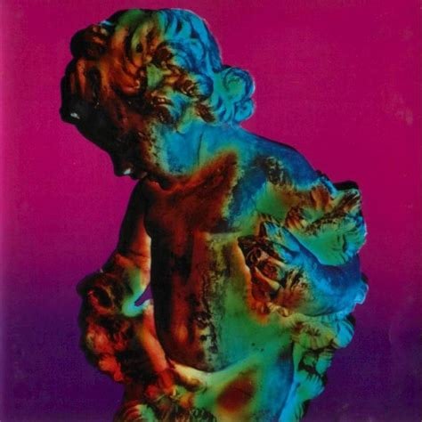 A color photo of a statue, some kind of cherubic figure, holding some kind of plants, leaves, I think. The lighting on it colors it from dark red to green to blue. The upper part of the background is dark pink, and that turns into dark purple by the bottom.