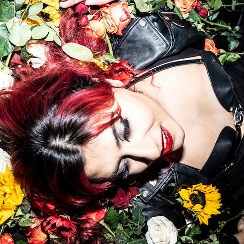 a woman lying on flowers