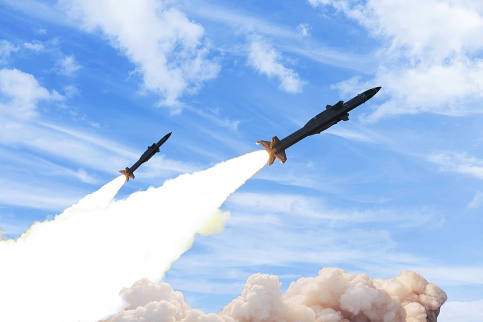 Two ballistic missiles being fired from mobile launchers