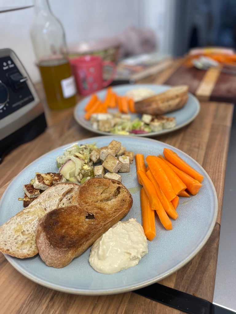 carrot sticks and tofu and hummus and toast on a plate