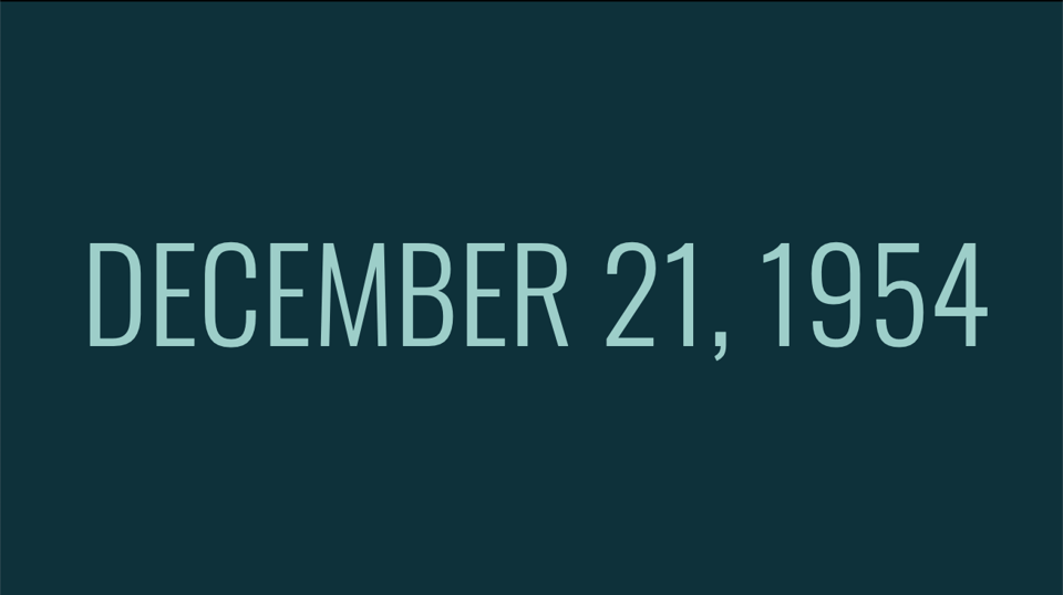 Very plain Powerpoint slide that just says "December 21, 1954"