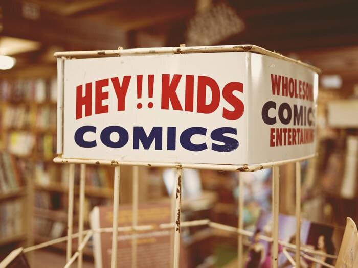 the top of a spinner rack with the text "hey kids!! comics"