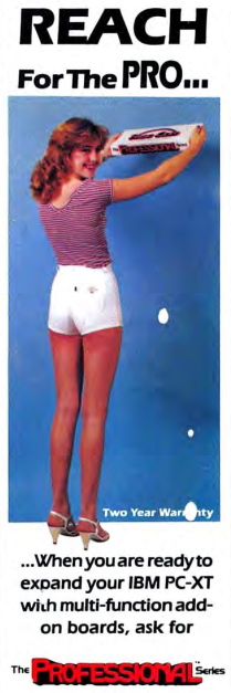 A woman is standing, facing away from the camera. She is wearing short shorts, high heels, and a short sleeved t-shirt, while holding some sort of computer hardware above her head and turning to look back at the camera.