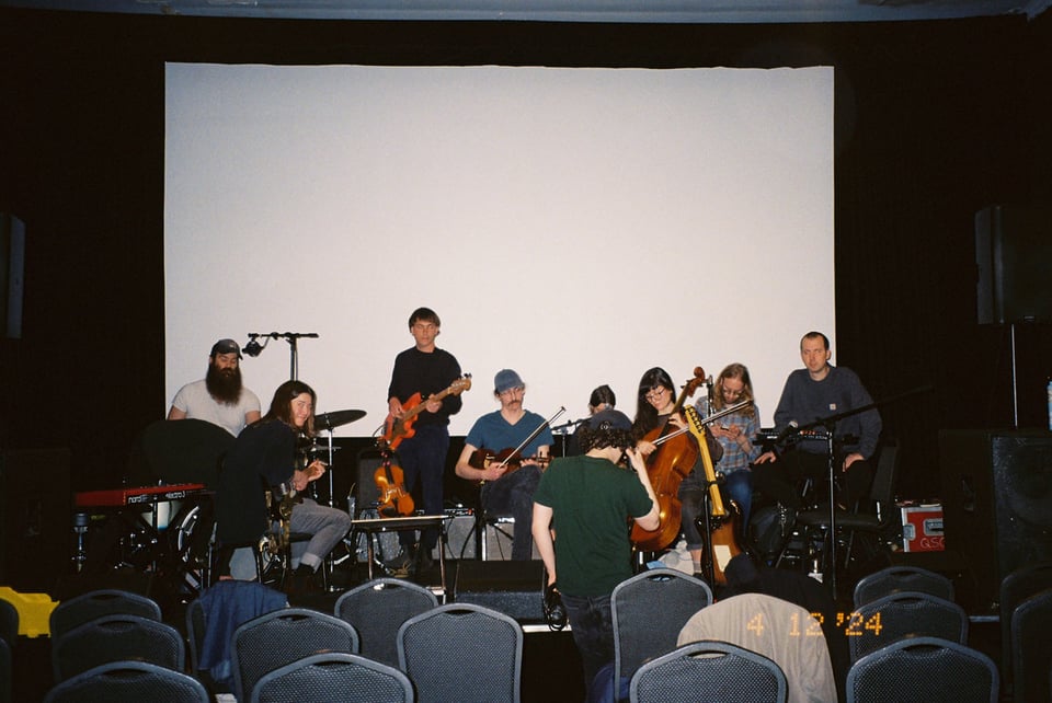 a very large ensemble soundchecks on stage