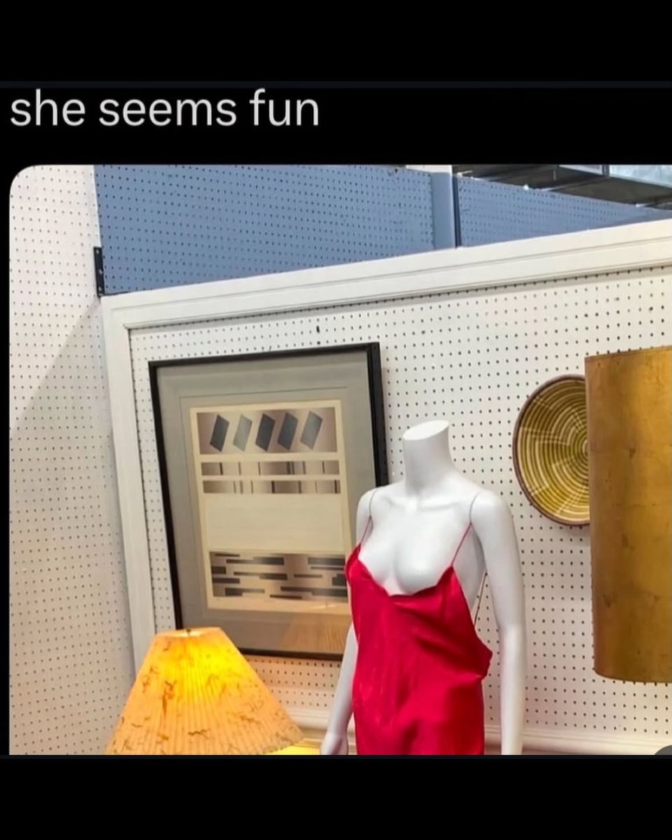 a meme of a female-figured mannequin modeling a red strappy slip, which is falling off its breasts. the photo caption says "she seems fun."