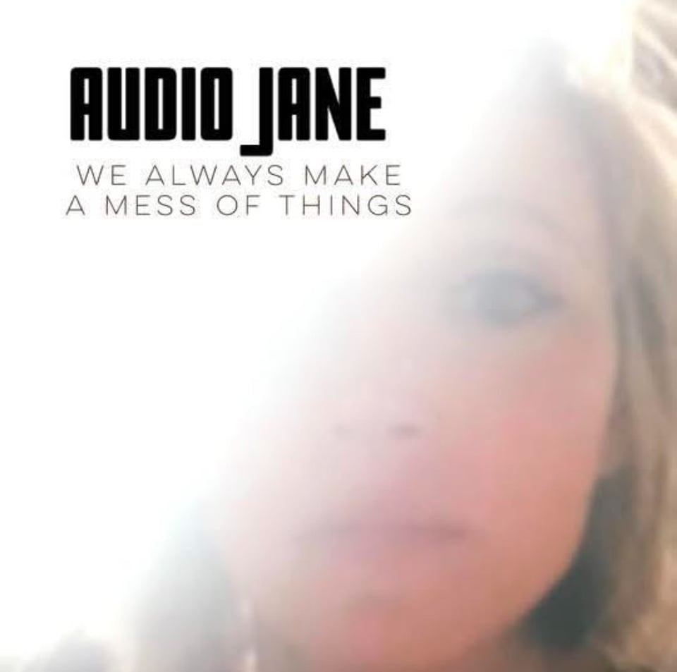 An album cover featuring a woman's face in soft focus, the band name