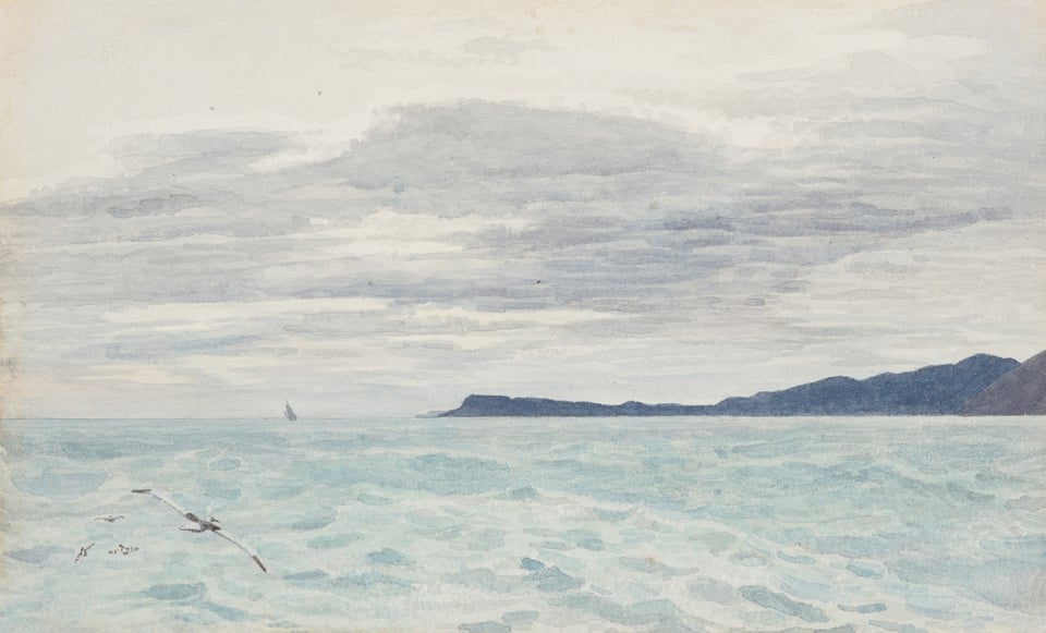 Light blue sea and dark shores in the background