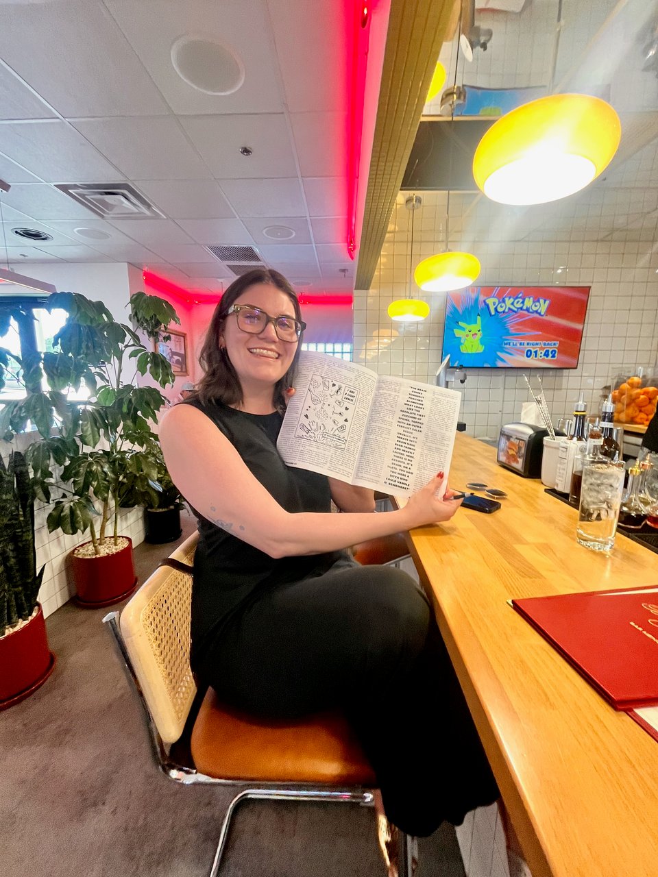 Becca of Chic! holding my copy of Guts! magazine at the bar in Bad Jimmy's