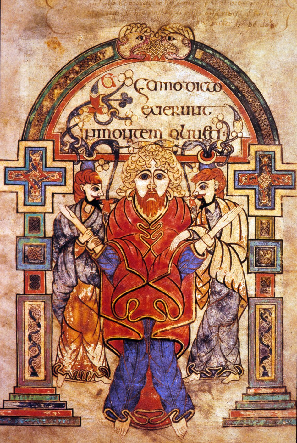 An image from The Book of Kells, a famous Irish illuminated manuscript. The image shows a man with two smaller figures on either side holding his arms. The man is wearing red and blue clothing. The scene is surrounded by pillars that come together to form an arch. An inscription in an ancient language is above the man's head and within this arch. The arch is ornately illustrated with celtic knots, crosses, and bright colors.