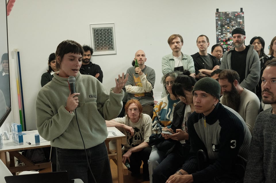 Speaker Beatrice Fini gestures as she talks in front of an audience