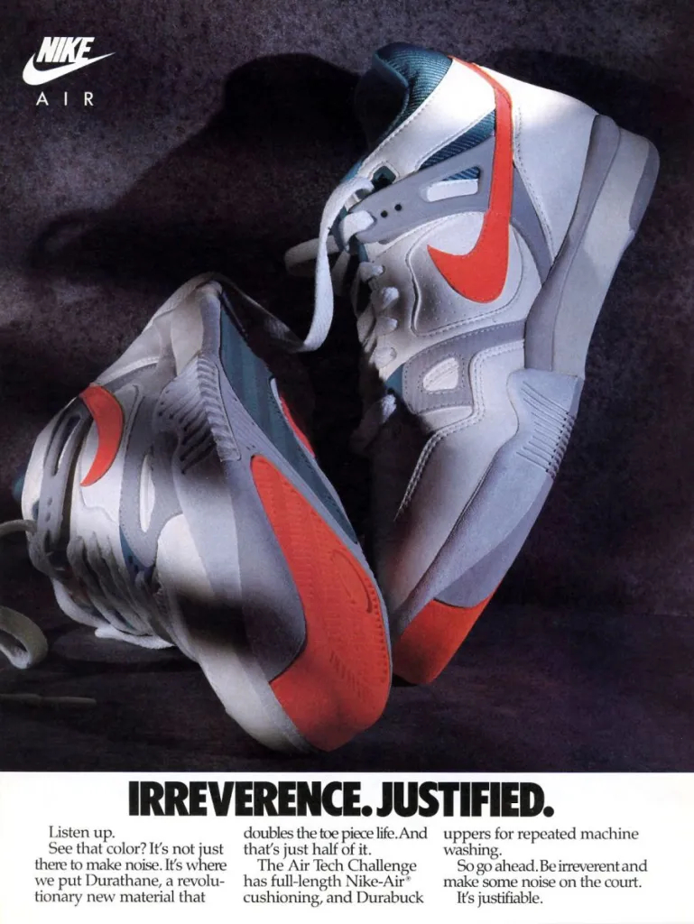 A magazine advert for Nike Air sneakers. A photograph of a pair of sneakers. They are mostly white and grey, so the red Nike Swoosh logo and the red toe piece are conspicuous in the image. The headline reads,