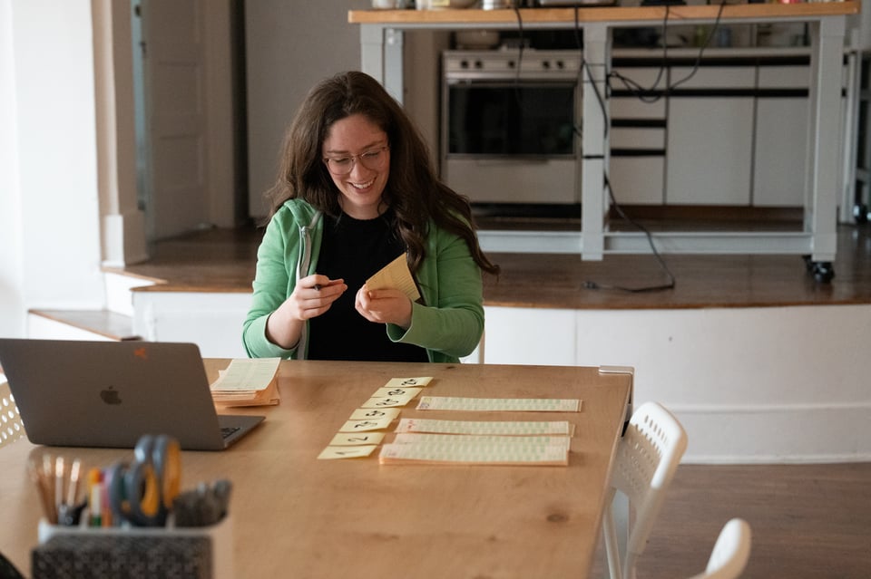 Jessica happily tallying time cards.