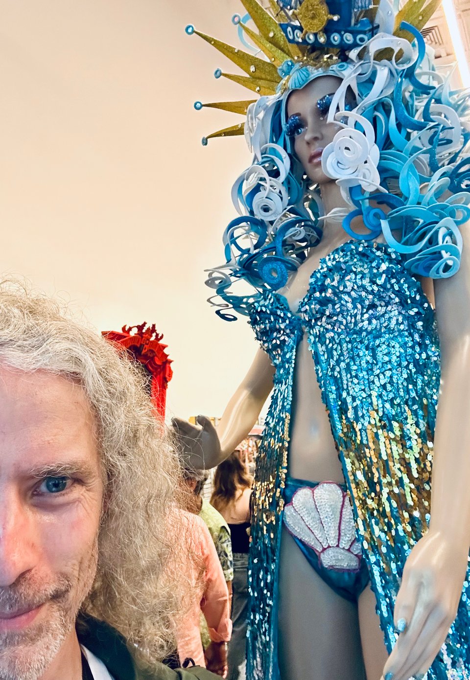 photo of white man's face as he stands beside a mannequin in a Mermaid Parade costume