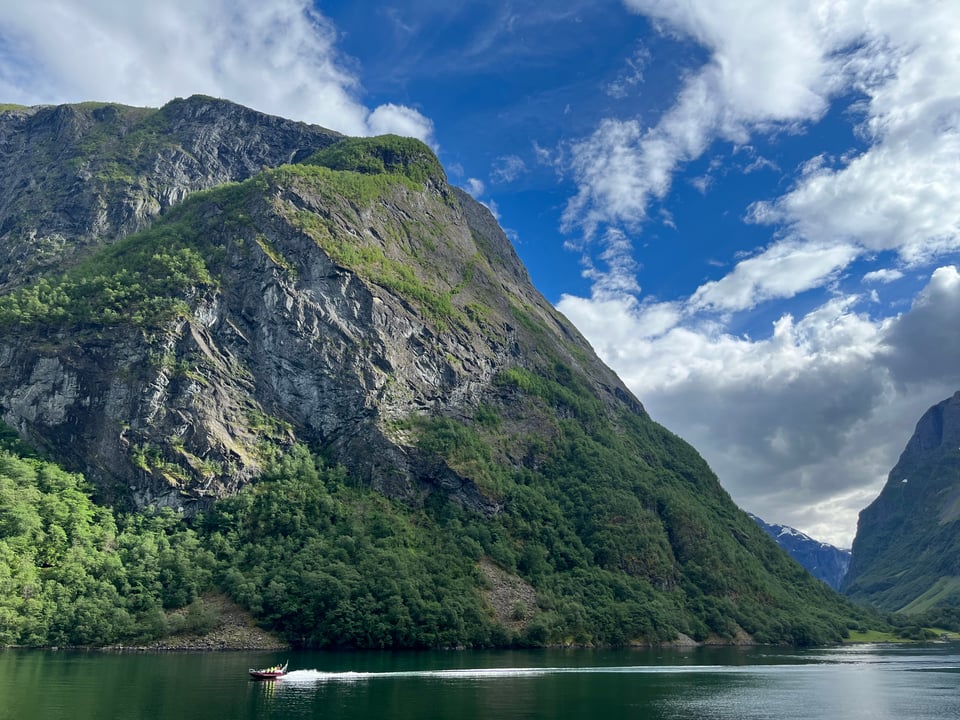 Fjord with boat in front of it