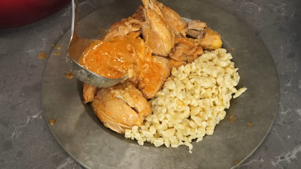 A plate of chicken and other food